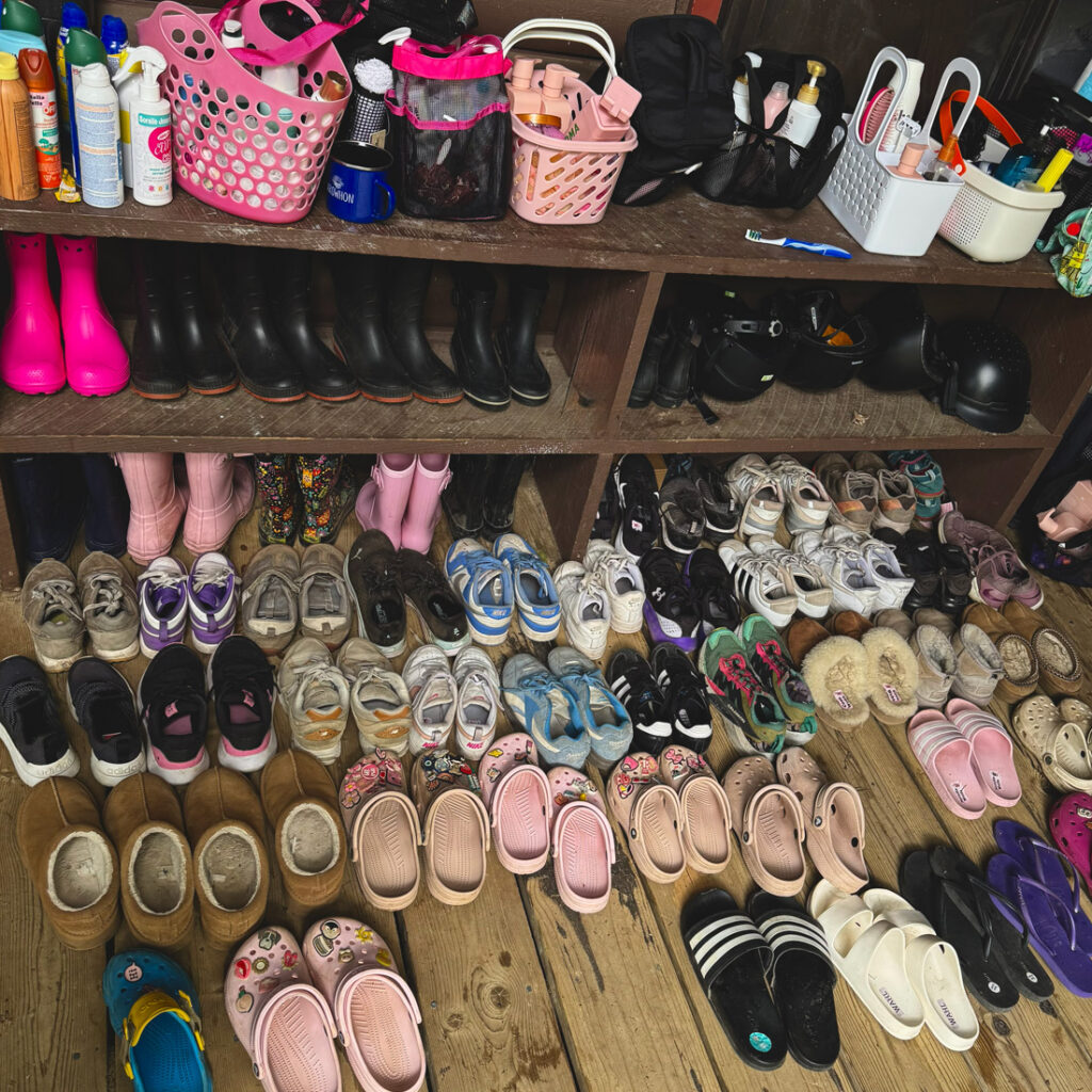 packing list: rows of shoes lined up at camp arowhon