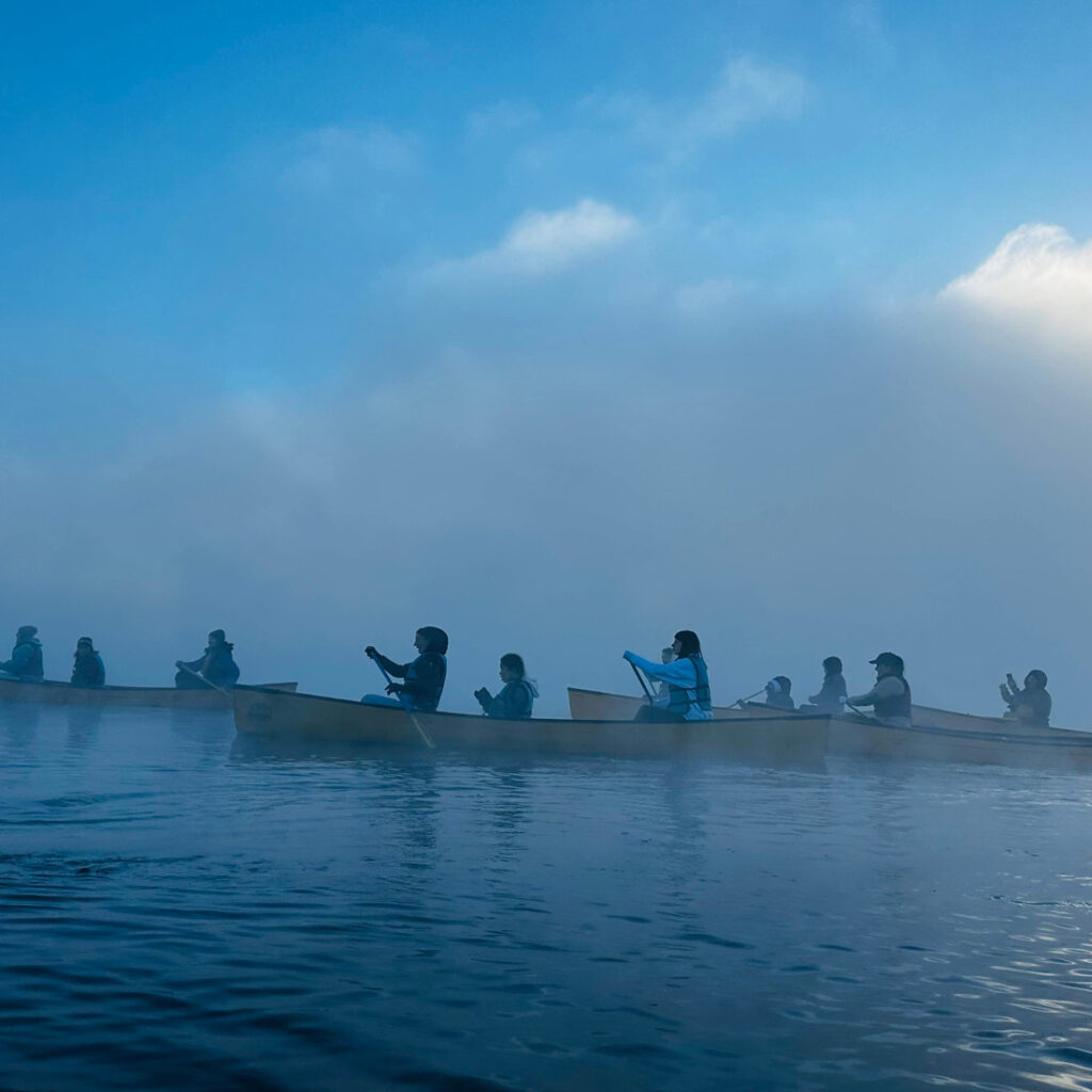 campers paddling in the fog