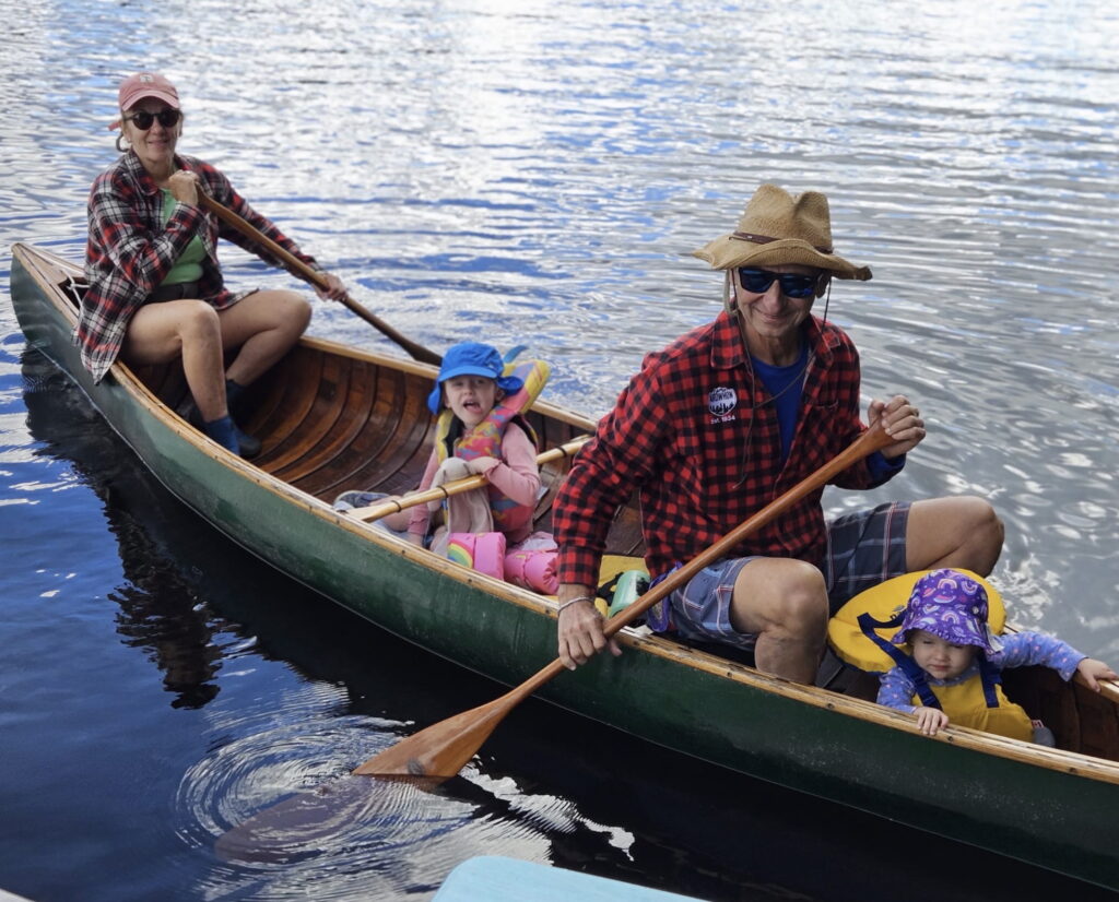 joanne kates and leon in a canoe with 2 grand kids